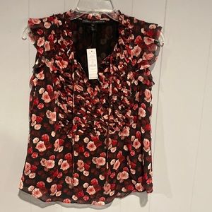 Sleeveless ruffle front top.